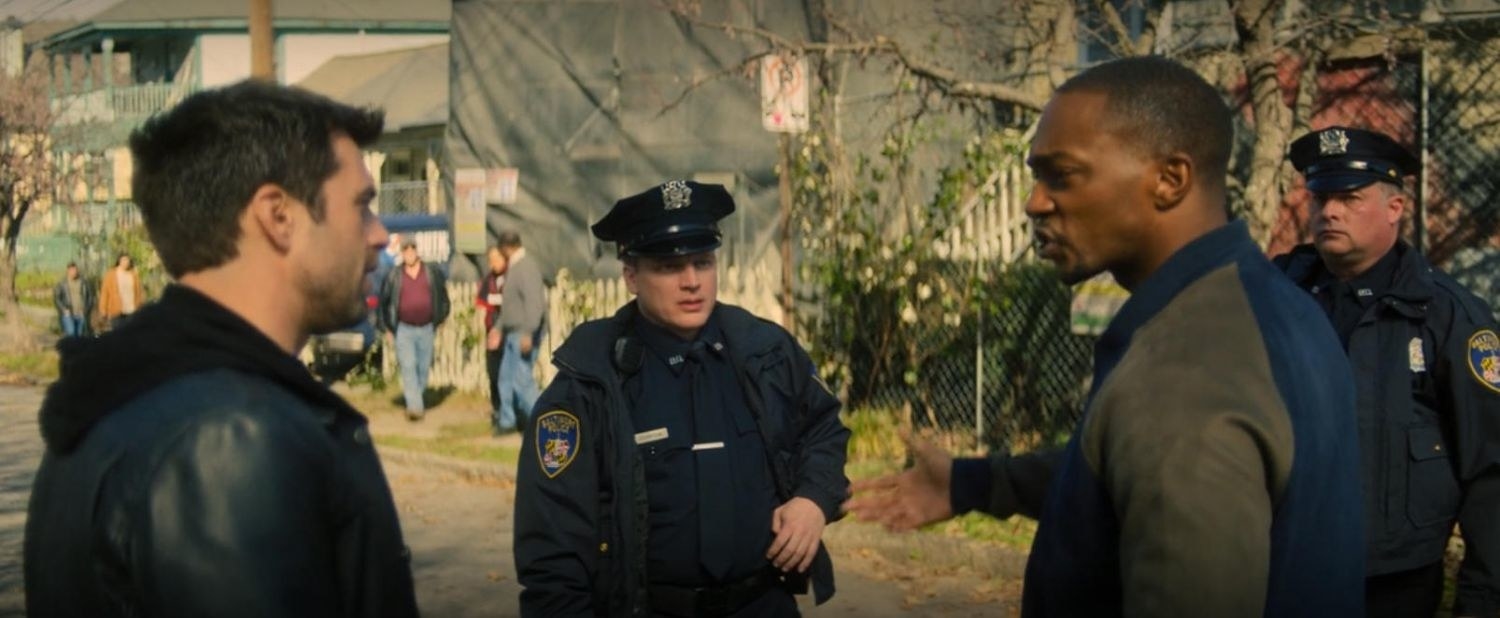 Sam Wilson surrounded by police officers