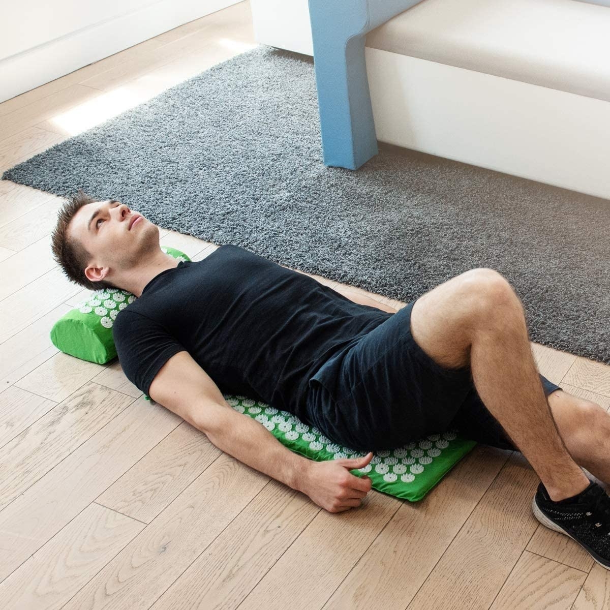 A person lying on the acupressure mat 