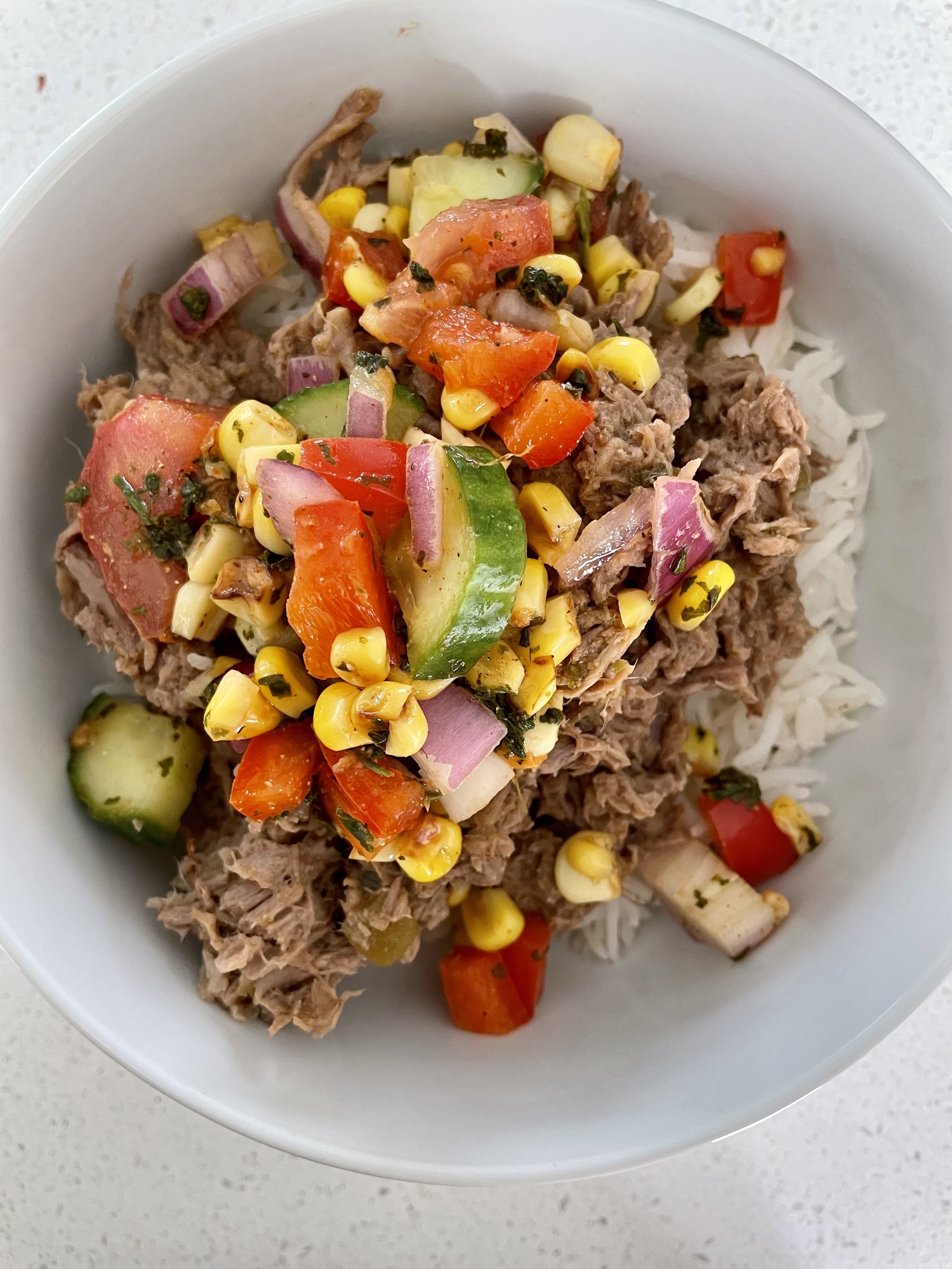 Burrito bowls plated with corn salsa