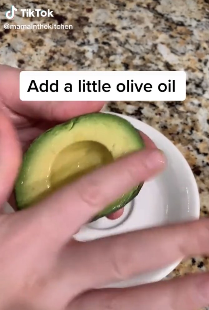 Rubbing a bit of olive oil onto an avocado