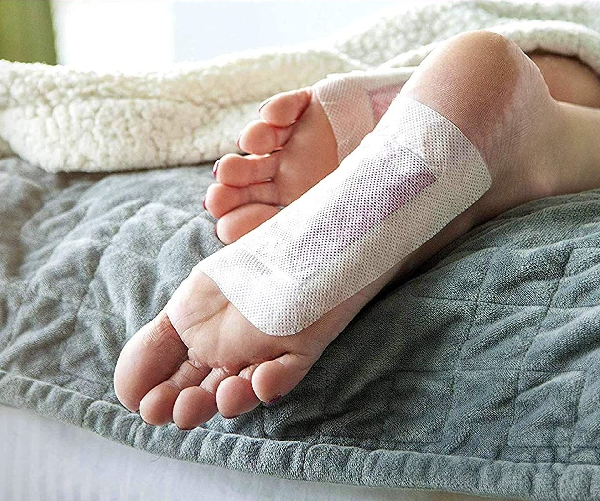 A close up of the bottom of a person's feet where the pads have been applied