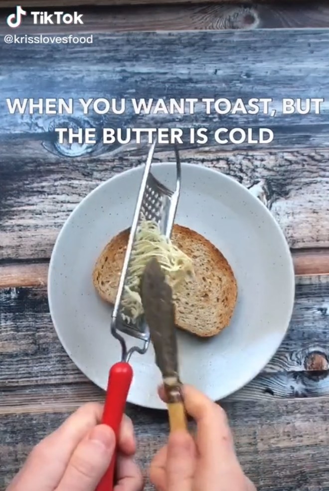 Butter being scraped from a cheese grater onto toast