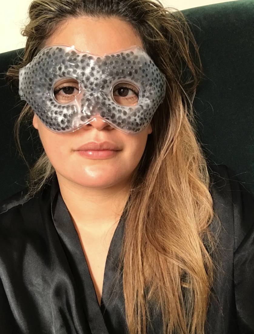 Reviewer wearing gray eye mask strapped around their head 
