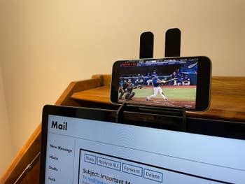 Smartphone placed in mount attached to laptop