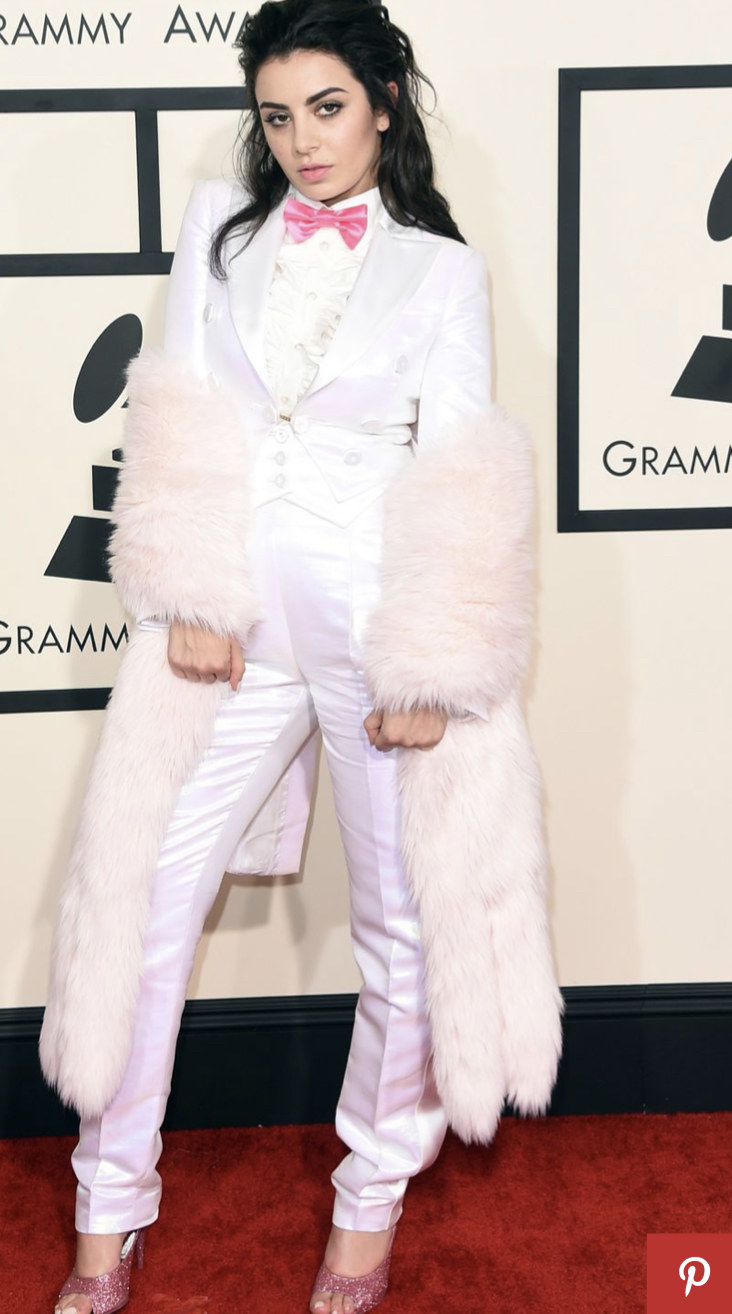 Charlie XCX in a pink-and-white suit with fluffy sleeves