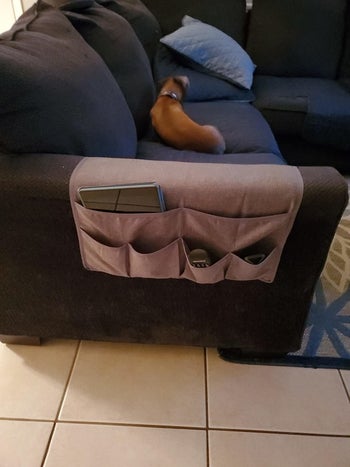 Reviewer's couch caddy placed over arm rest
