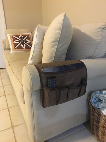 Reviewer's couch caddy placed over arm rest