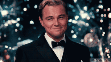 Leo in Great Gatsby cheering with his drink
