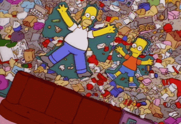 Homer and Bart Simpson making snow angels in trash in their living room