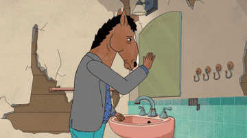 BoJack Horseman uses his hand to wipe grime away from a dirty bathroom mirror before looking into dejectedly. 