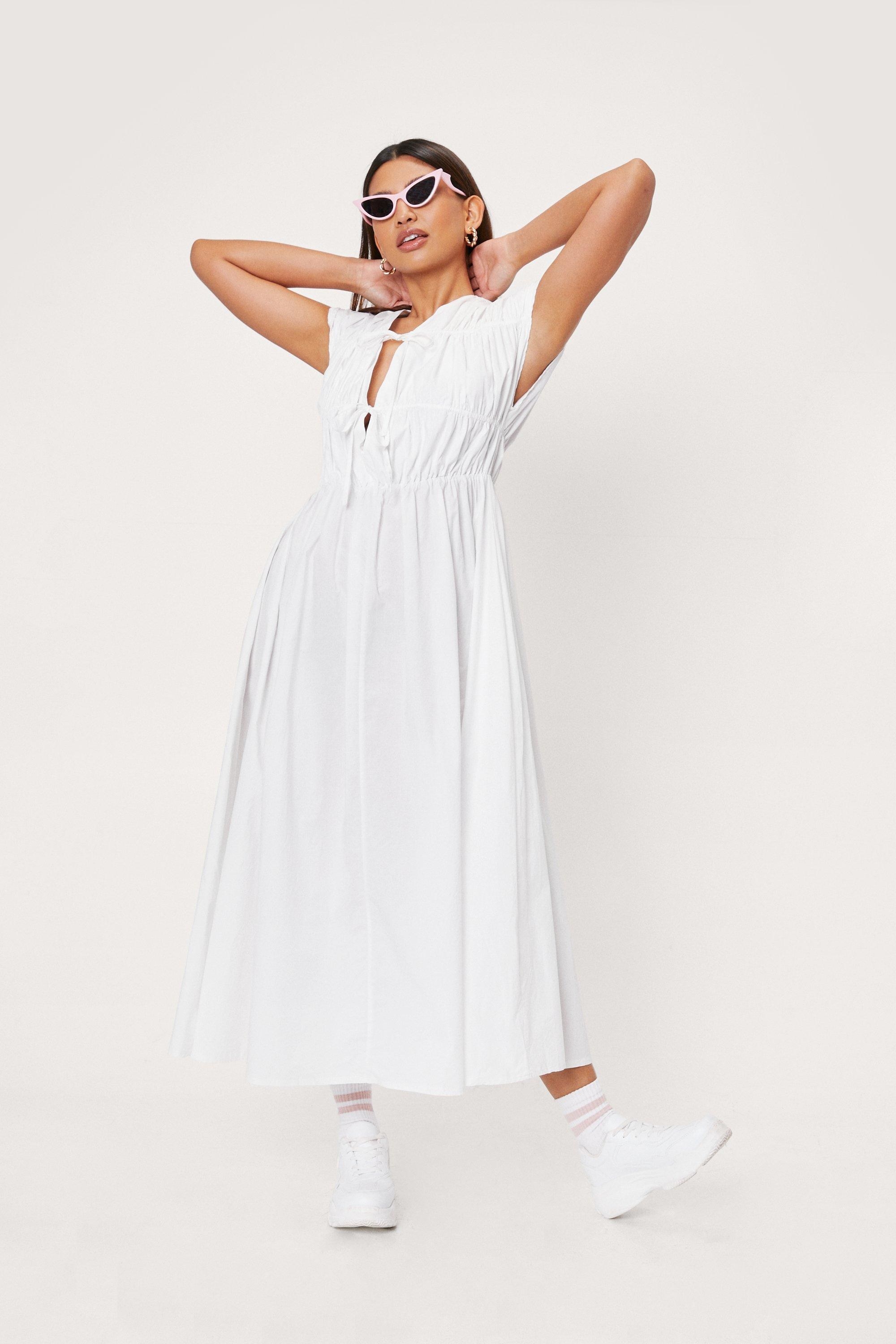 white midi dress with two bows on the front 