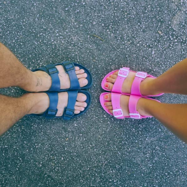 two reviewers&#x27;s pairs of feet: one in the blue, the other in the pink Birkenstocks