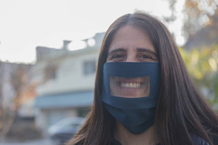 A woman wearing a transparent face mask