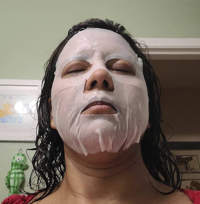 reviewer wearing one of the collagen face mask