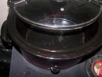 Reviewer showing how clean slow cooker is after using liner