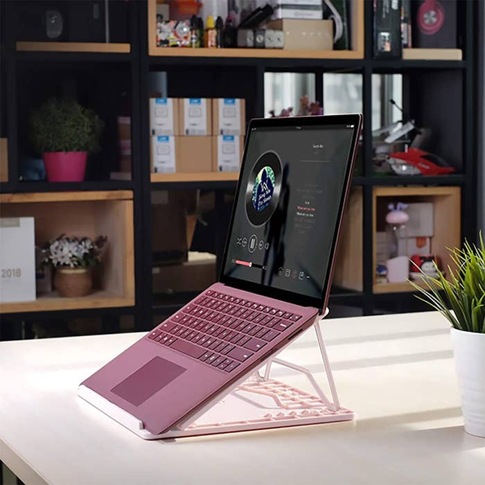 A laptop on top of the stand