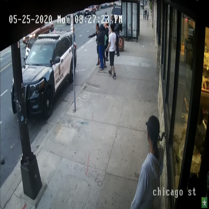 Christopher Martin seen calling his mom on his cellphone away from the group of bystanders