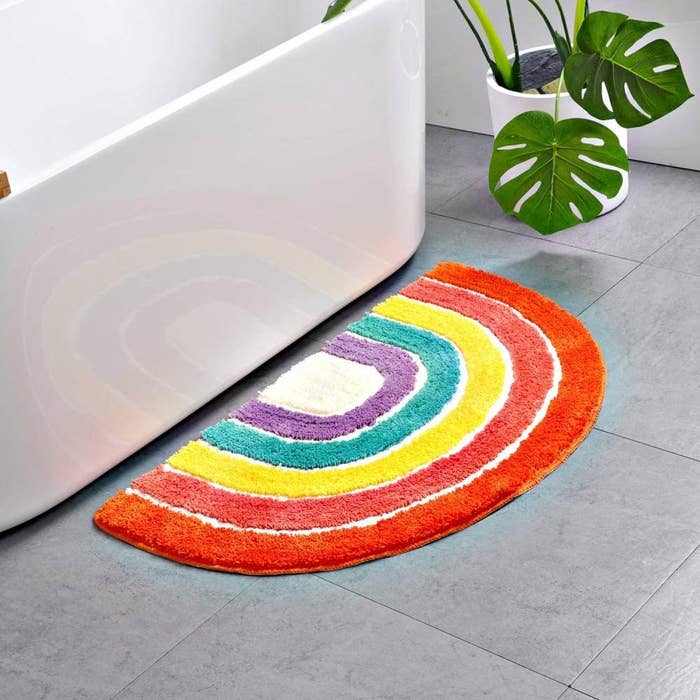 The rainbow mat in front of a tub