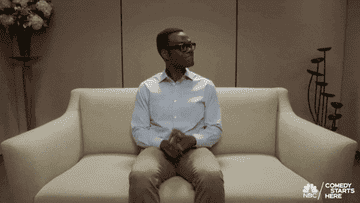 Chidi from &quot;The Good Place&quot; getting up from a couch