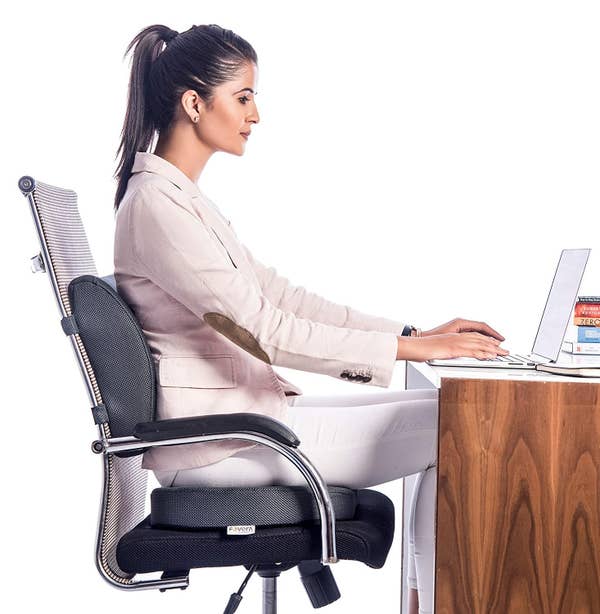 A woman sitting on a memory foam seat cushion