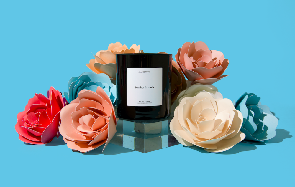 The black candle jar next to paper roses