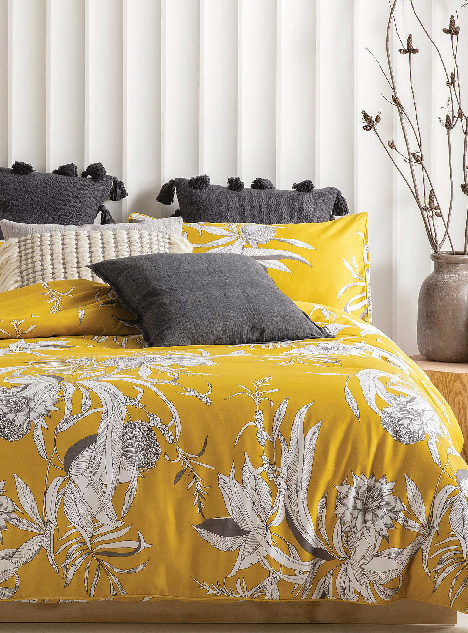 A duvet on a bed with a bunch of pillows