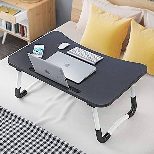 A laptop desk with a laptop on it