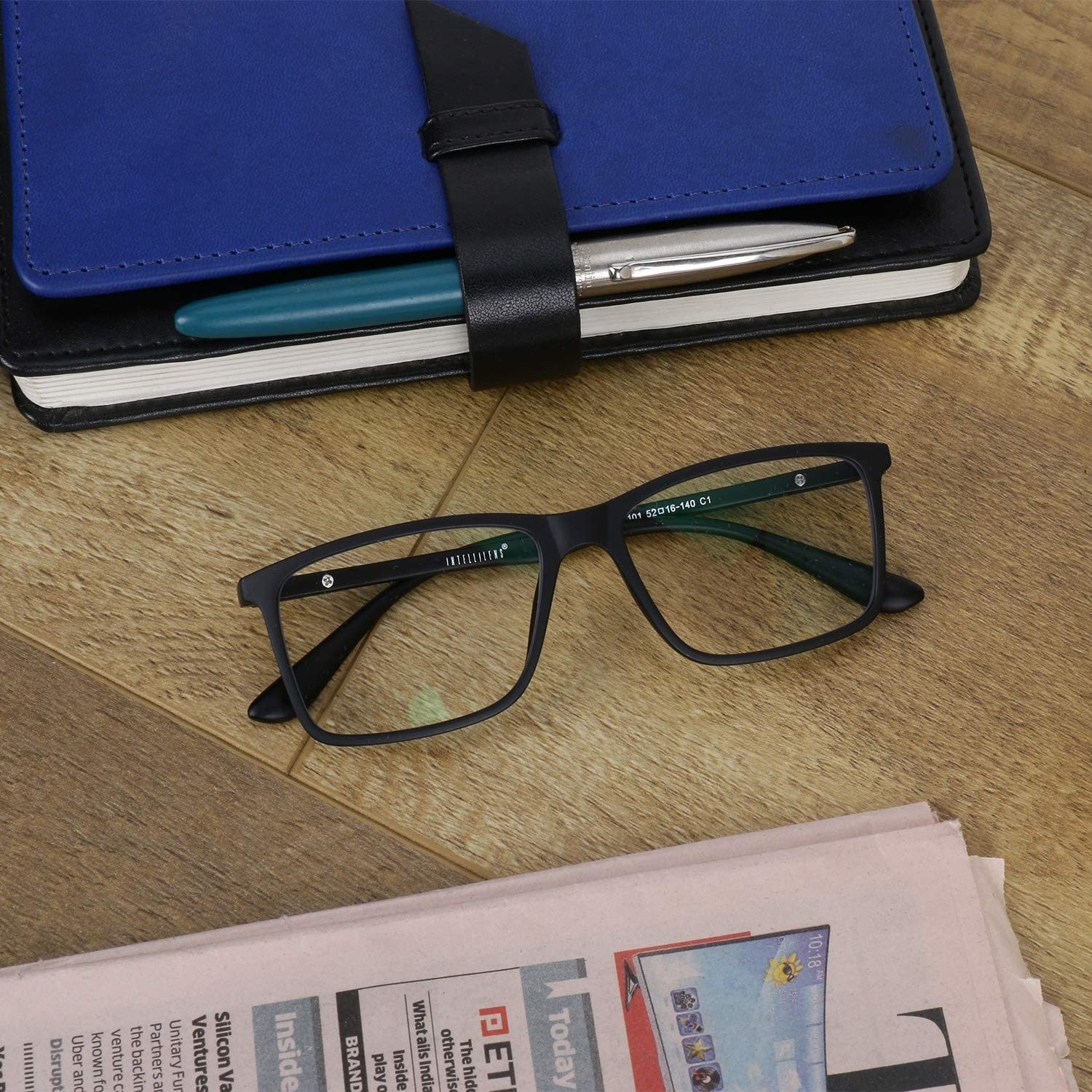A pair of blue light blocking glasses on a table