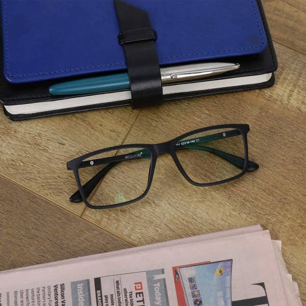 A pair of blue light blocking glasses on a table