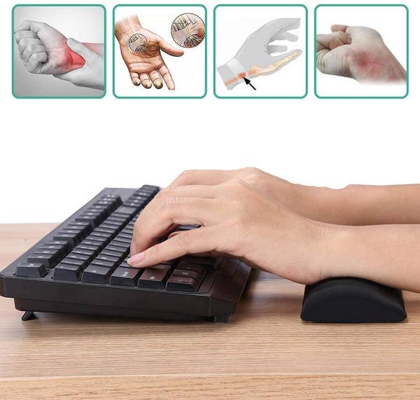 A person typing with the memory foam wrist pad