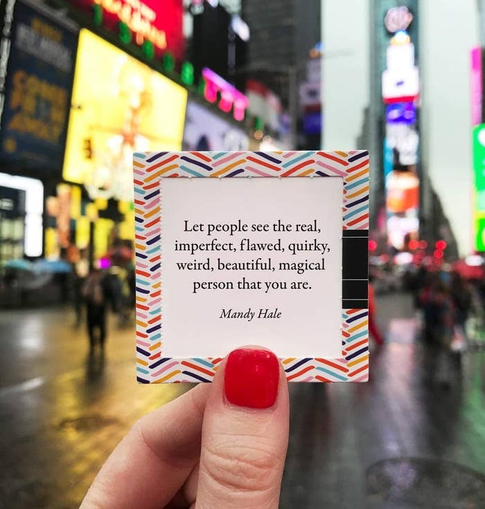 Someone holding up one of the pop-open affirmation cards