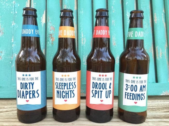 Four beer bottles with labels that say dirty diapers, sleepless nights, drool and spit up, and three am feedings