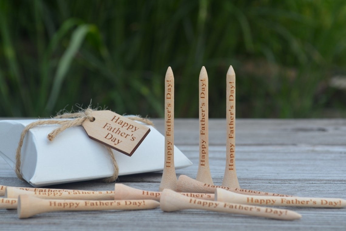 Several wooden golf tees that say &quot;Happy Father&#x27;s Day!&quot; 