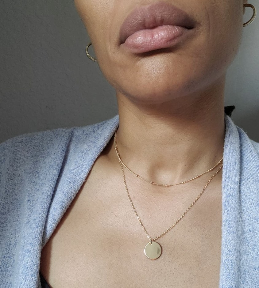 A person wearing a layered necklace