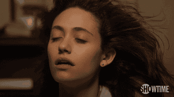 A gif of Emmy Rossum from Shameless throwing her head back in ecstasy