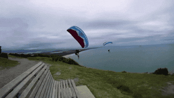 Paraglider landing seated on a bench