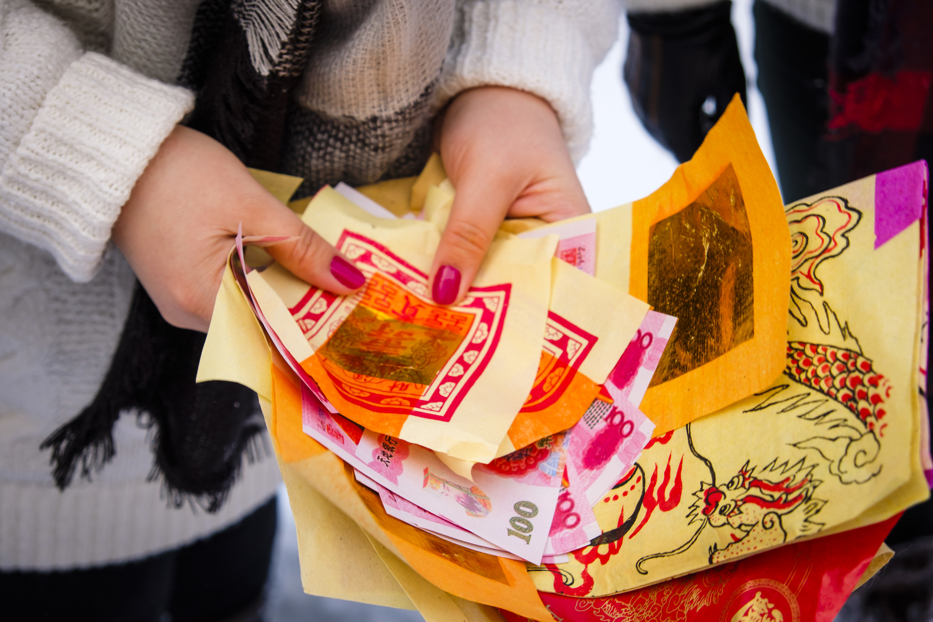 Closeup of hands holding joss paper