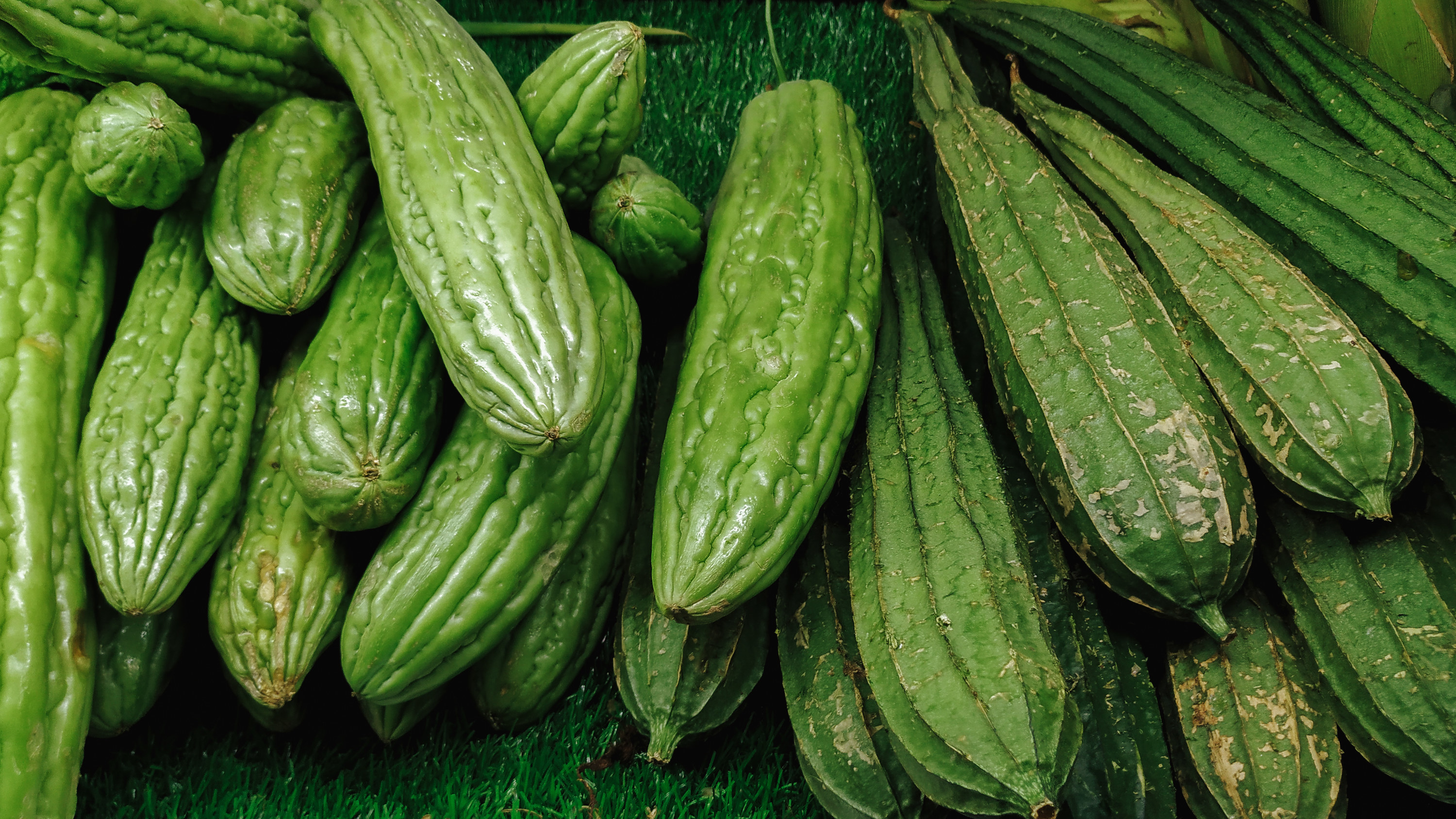 Group of green bitter melon vegetables lying on top of each other