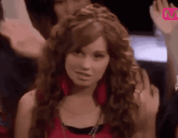 Debby Ryan pushes back her bangs and makes a strange smirk