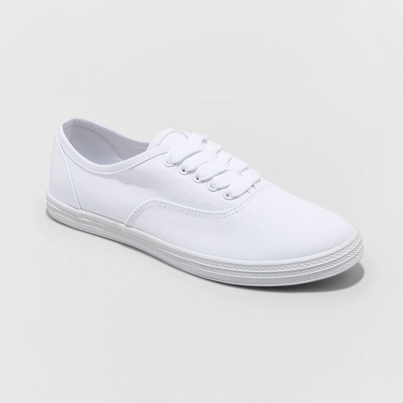 All white sneakers with laces and rubber sole