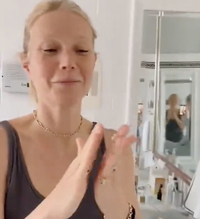 Gwyneth rubs a product in her hands before putting it on her face
