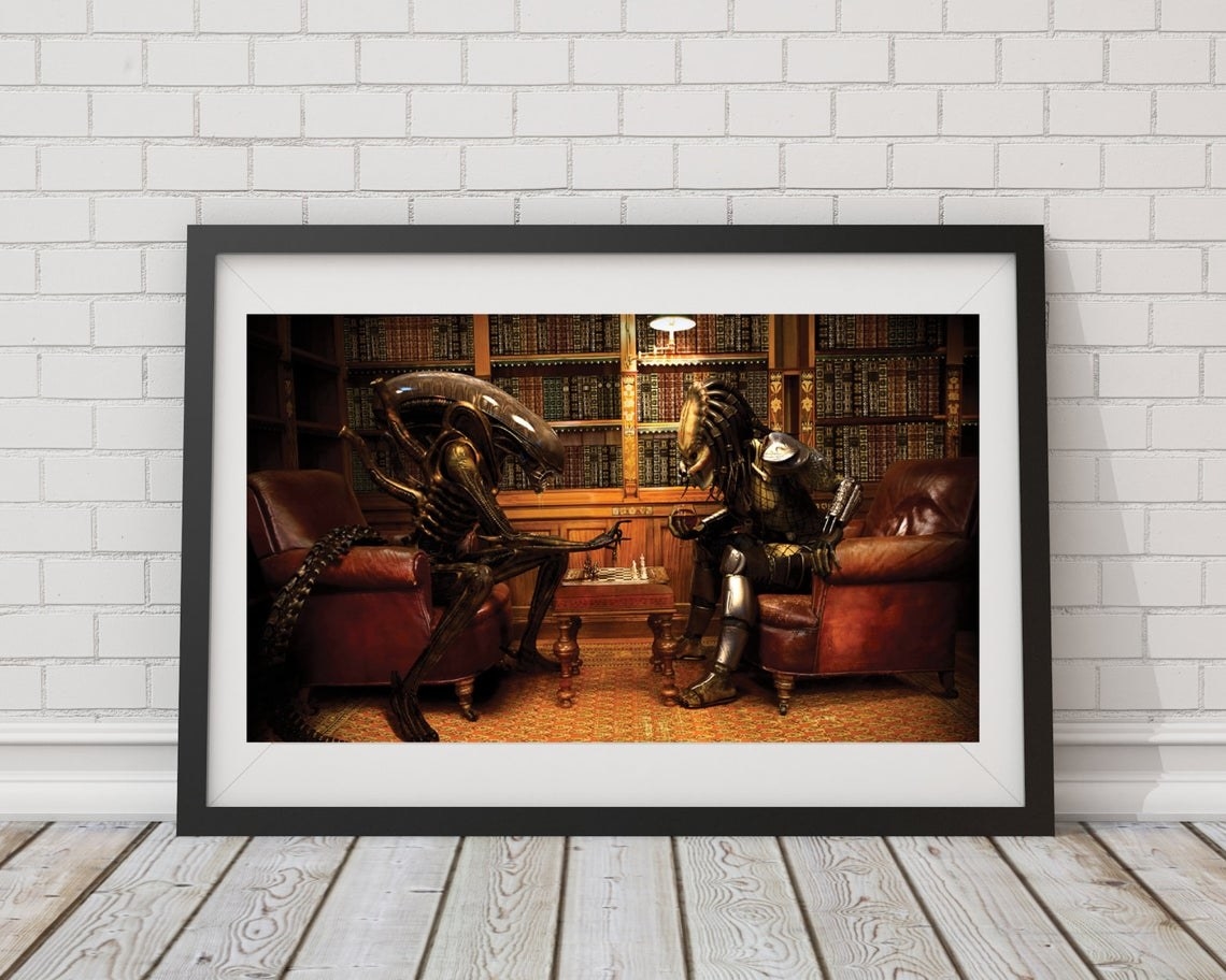 A funny print of Alien and Predator competing in a game of chess 