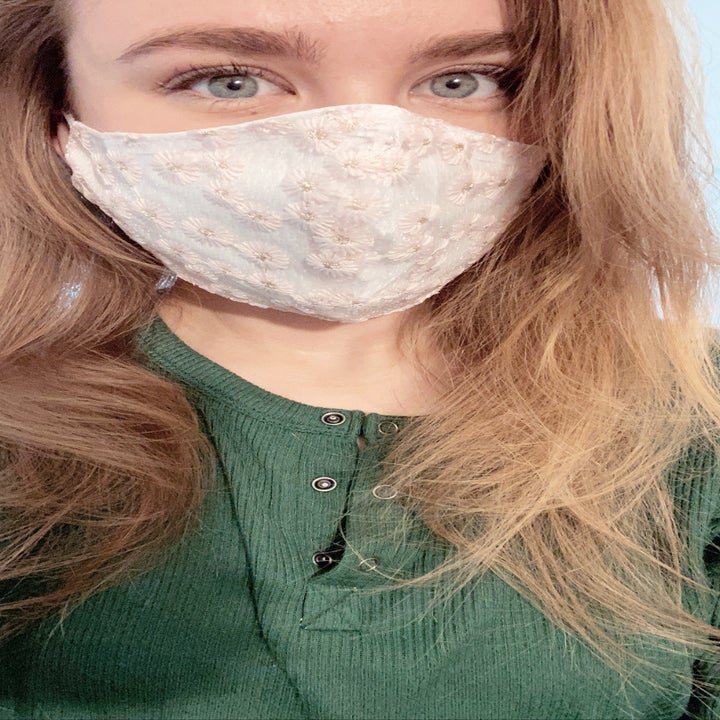 A BuzzFeed editor in a white mask with pink embroidered florals 