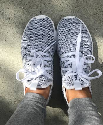a reviewer wearing the sneakers in grey