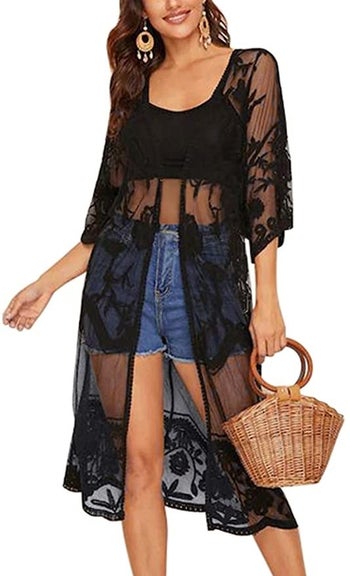 model wearing the knee-length open front lace kimono over a crop top and shorts