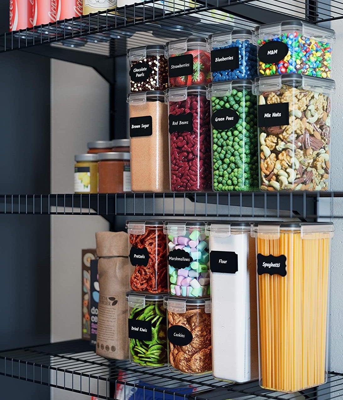 A set of plastic food containers with chalkboard labels arranged neatly on a pantry shelf