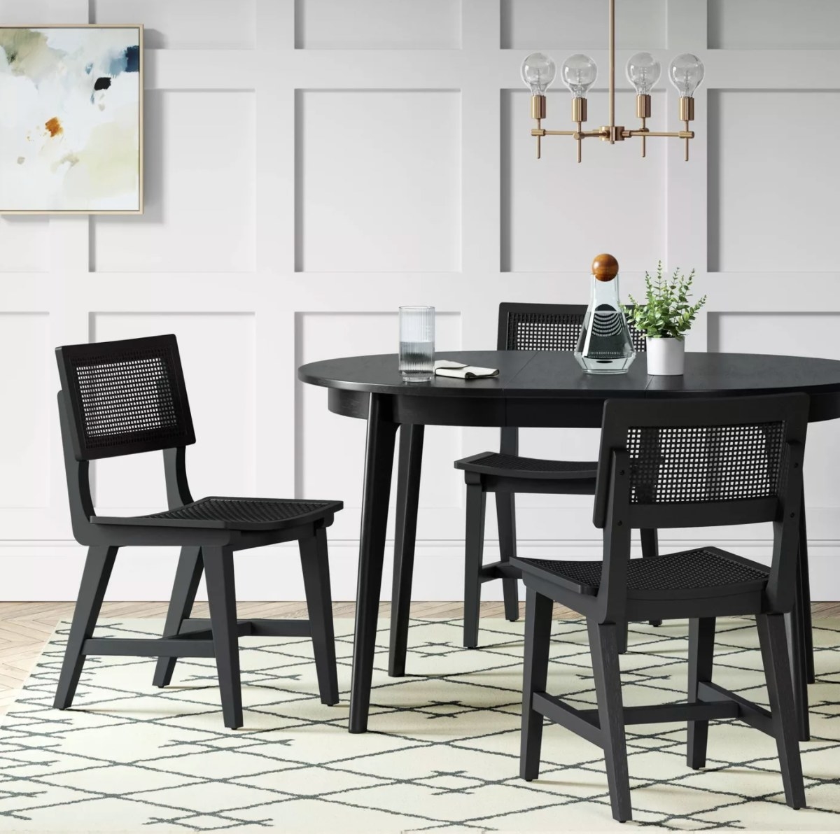 The midcentury round extendible table with matching chairs in black