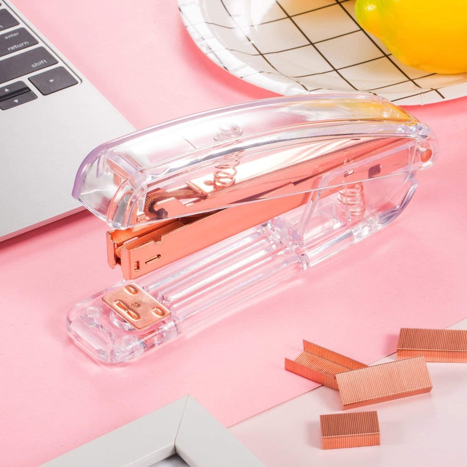 the stapler on a desk next to staples