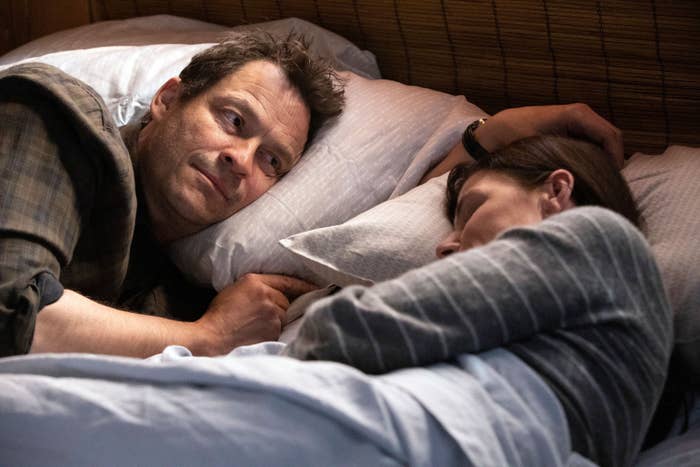 Dominic West looks at Maura Tierney, who&#x27;s in bed sleeping