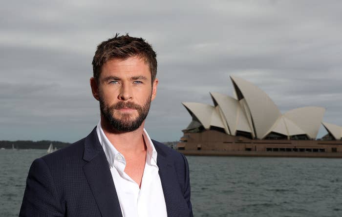 Chris Hemsworth standing in front of the Sydney Opera House 